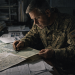 Analista militar revisando mapas detallados